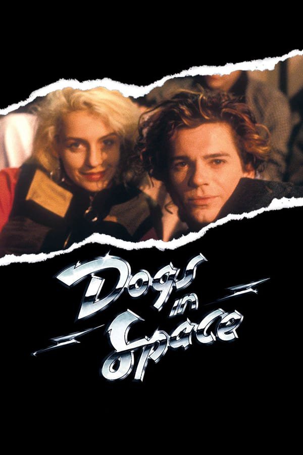 The black theatrical poster for Dogs in Space, with a tear through the middle with the logo written slanted and punk rock-like, with a curly-haired man and blonde woman staring out of the tear