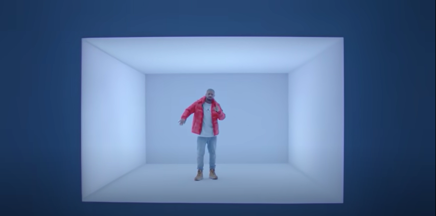 An image of a man in a red puffer jacket dancing in a small rectangular room in shades of blue, surrounded by a glowing border of deeper blue