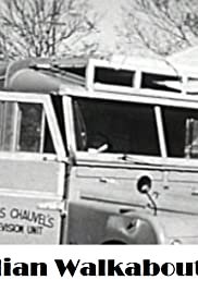 An old black and white picture of a van at a camping ground