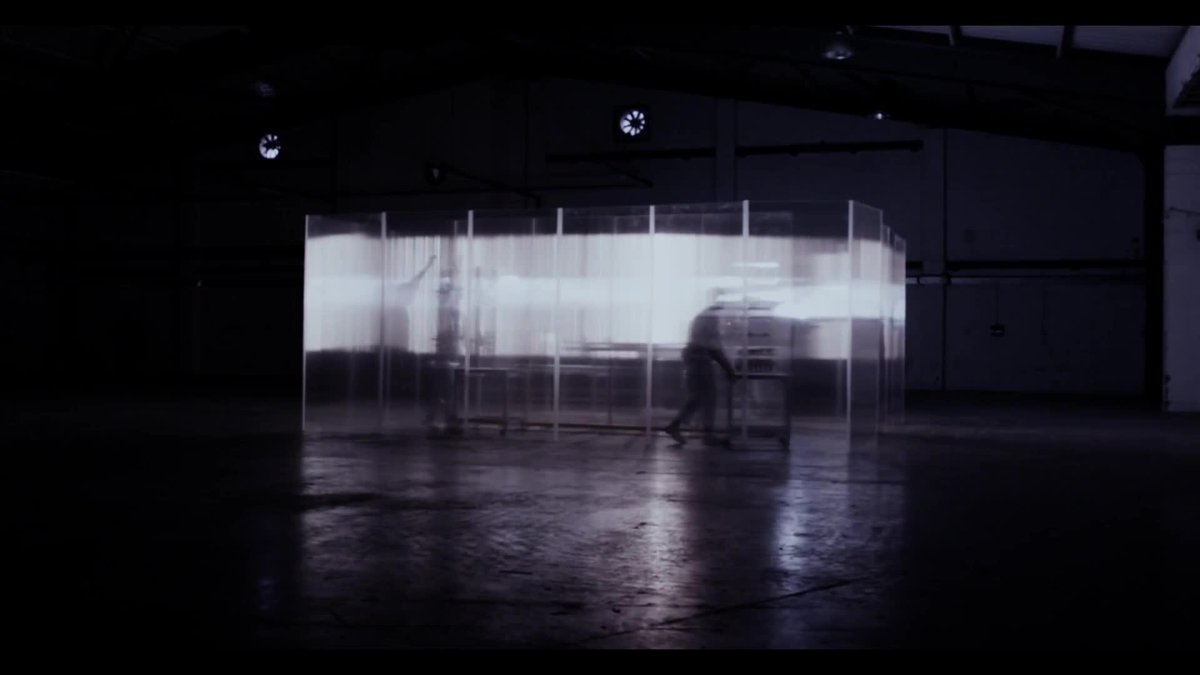 A blurry image of a factory floor rendered in cold blues